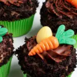 Easter chocolate cupcakes decorated with chocolate-covered strawberries and crushed Oreo crumbs.