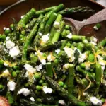 Fresh asparagus salad with peas, feta, and mint on a plate