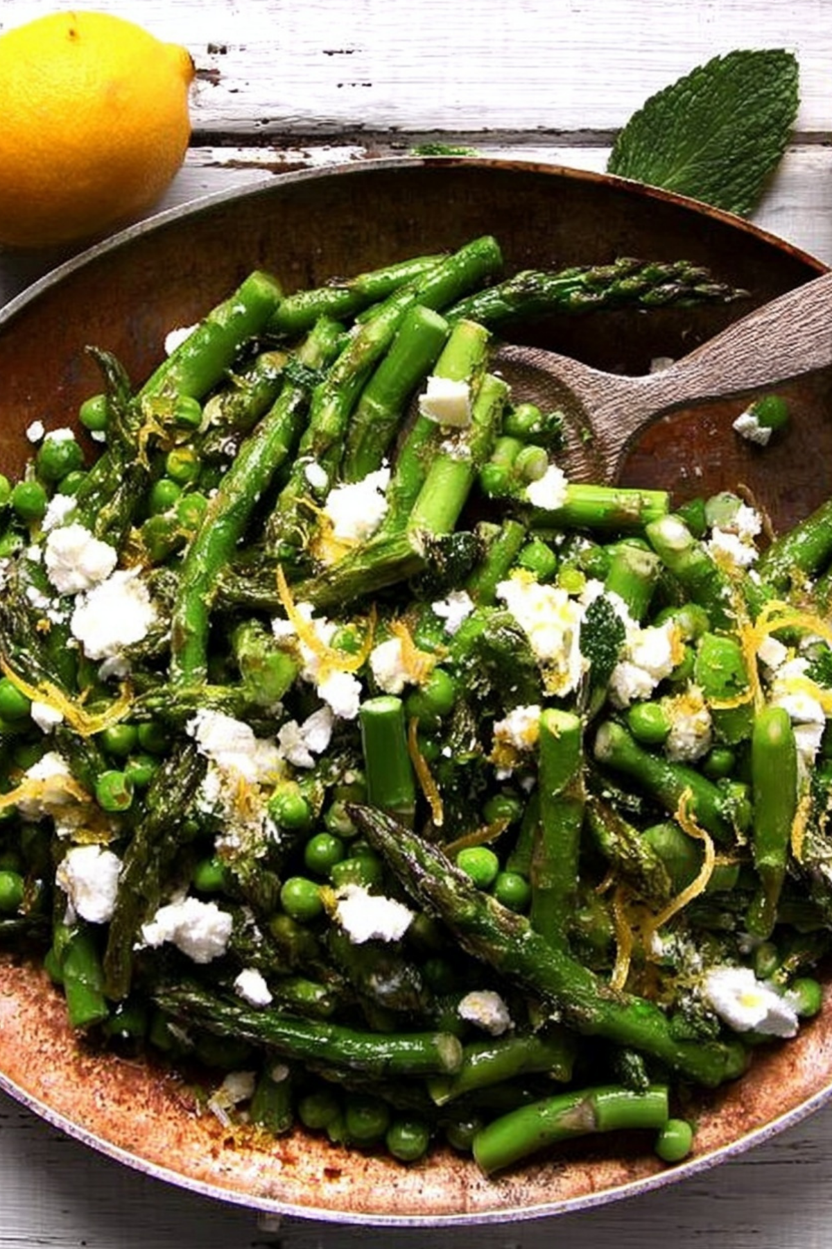 Fresh asparagus salad with peas, feta, and mint on a plate