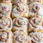 Funfetti cinnamon rolls with colorful sprinkles and cream cheese frosting