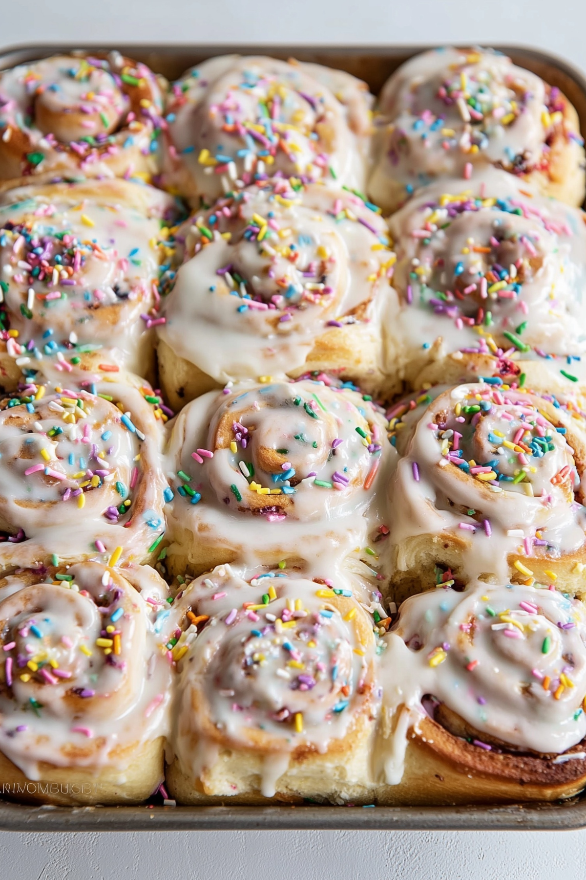 Funfetti cinnamon rolls with colorful sprinkles and cream cheese frosting