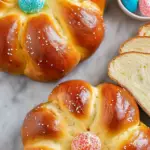 Italian Easter Bread decorated with colorful sprinkles and a hard-boiled egg in the center