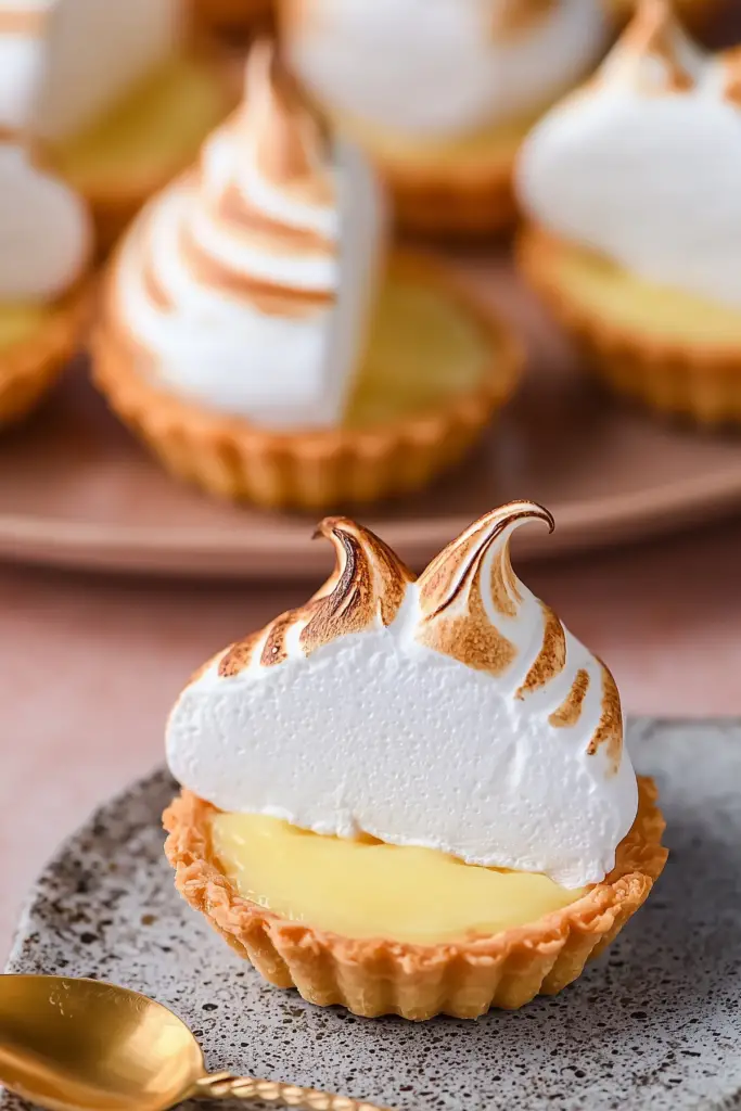 Mini Lemon Meringue Tarts with meringue topping and lemon filling